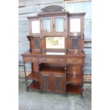 An Edwardian walnut dresser, the upper section fitted three mirror panels and glazed cupboard,