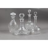 A cut glass spirit decanter, two cut glass sherry decanters and a cut glass ship's decanter, tallest