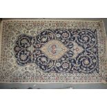 A Persian prayer rug with all-over scroll design on a blue and cream ground, 44" x 77" approx