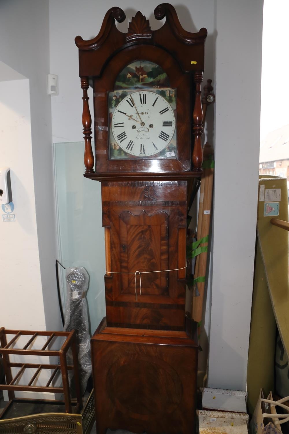 An early 19th century mahogany and banded long case clock with painted dial and striking movement,