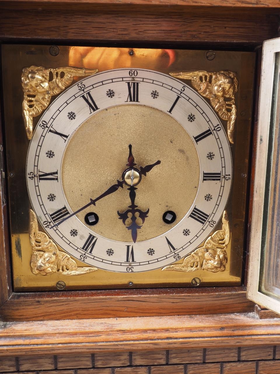 An oak cased mantel clock with carved decoration, silvered and gilt dial, and Roman numerals, on - Image 3 of 4