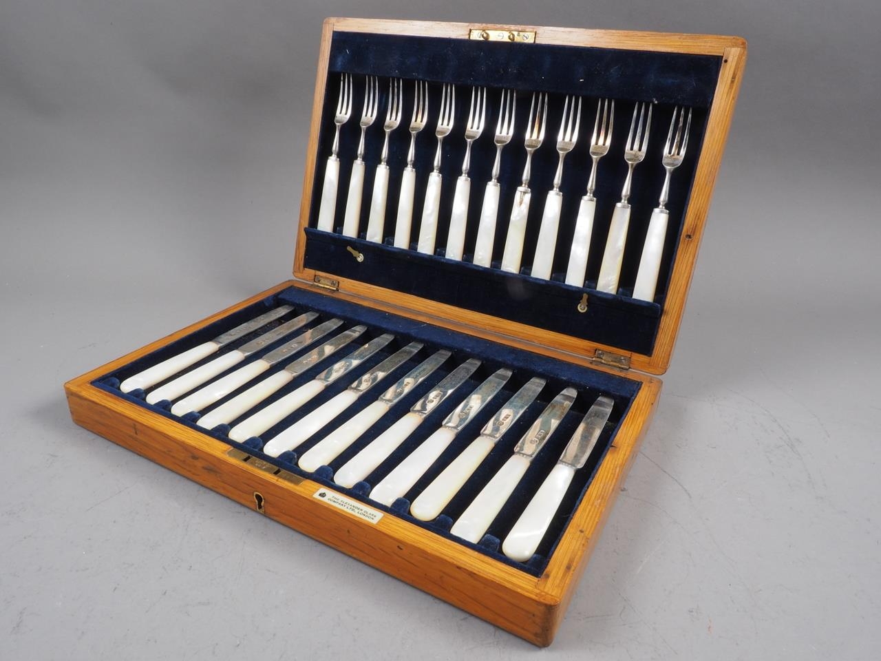 A cased set of twelve silver and mother-of-pearl fruit knives and forks