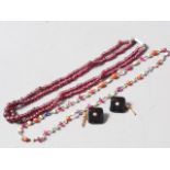 A two-strand graduated garnet bead necklace, a garnet coral and blister pearl necklace and a pair of