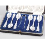 A set of six silver coffee spoons and matching tongs, in case