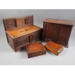 An early 20th century oak letter box with carved decoration, 15" wide, a similar desk tidy, a pair