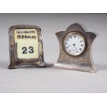 An Edwardian silver mounted desk clock with engraved decoration, white enamel dial with Roman