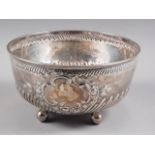 A Victorian silver bowl with embossed decoration, on four bun feet, 9 1/2" dia, 29oz troy approx