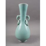 A Chinese celadon glazed vase with mask and ring handles, 11" high