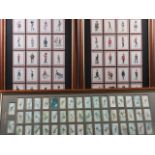 A set of framed cigarette cards, "Aeroplanes", two sets of "Caricatures of the British Army", in