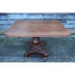 A 19th century mahogany rectangular tilt top breakfast table, on turned column and quatreform