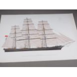 A colour print of the Cutty Sark, unframed, and a folio of prints "Spoils of War, Portraits of the