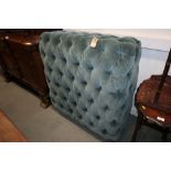 An OKA ottoman, button upholstered in a blue green velour, on turned supports, 42" square x 15" high