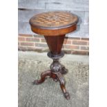 A late 19th century walnut, rosewood and satinwood inlaid circular games/worktable, on carved column