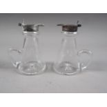 A pair of silver mounted glass whisky noggins with star cut bases, 3 3/4" high
