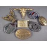 Five brass belt buckles, including one formed as a bull's head, and three other belt buckles