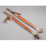 Two African swords with leather scabbards, blades 17" long approx