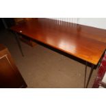 A cherrywood finish plank top dining table, on chrome supports, 59" wide x 28" deep x 26" high