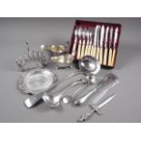 Two silver plated sauce boats, three ladles, a toast rack and other plate