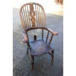 A 19th century Windsor splat back elbow chair, on turned and stretchered supports