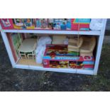 A Sindy three-storey doll's house, two Sindy dolls, a selection of Sindy doll's furniture comprising