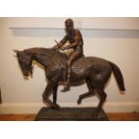 A bronze model of horse and jockey, on marble base, 37 1/2" high overall, said to be Lester Piggott