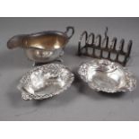 A silver sauce boat, 3oz troy approx, a silver six-division toast rack, 2.2oz troy approx, a