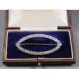 A white metal and diamond navette-shaped brooch, thirty-four old cut diamonds, 49mm wide overall,