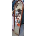 An early 20th century walnut framed arch top slip mirror with bevelled plate, 51" x 9"