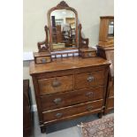 A 1920s polished as walnut dressing chest, fitted mirror and two jewel drawers, over two small and