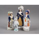 A 19th century Staffordshire bone china figure of a musician, 7 1/2" high, two smaller similar