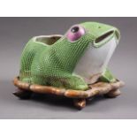 A Chinese plant pot, formed as a frog, on hardwood stand, 10" long x 8" high