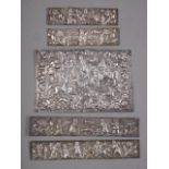 Five Persian embossed white metal plaques with figure and animal decoration