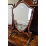 A mahogany shield-shape swing frame toilet mirror, on skeleton stand, 15" wide x 21 1/2" high