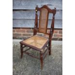 A child's walnut framed cane seat and back chair