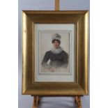 An early 19th century watercolour portrait of a woman with mop cap and lace collar, 9 1/4" x 6 3/4",