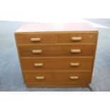 A 1950 light oak chest of two short and three long graduated drawers, on block base, 42" wide x
