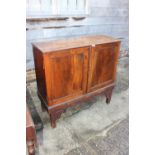 A 19th century fruitwood cupboard enclosed two doors, on later stand, 41" wide x 15 1/2" deep x