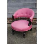 A late 19th century ebonised frame tub-shape occasional chair, upholstered in pink, on turned