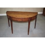 A late 19th century mahogany semicircular side table with box and ebony stringing, on square taper