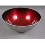 A retro aluminium and red enamelled bowl, 11" dia