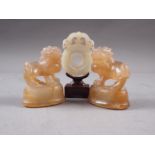 A Chinese green jade roundel with carved and pierced decoration, on stand, 2 3/4" high overall,