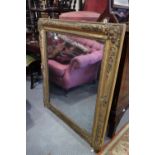 A late 19th century gilt and relief decorated overmantel mirror, frame 41" x 34" overall