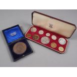 A cased 1953 Great Britain coin set and a cased bronze Midwifery medallion