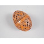 A 19th century turned, carved and pierced coquilla nut pomander, 2 1/2" wide