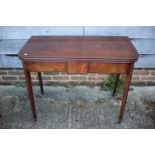 A 19th century mahogany fold-over top tea table, on square taper castored supports, 36" wide x 18"