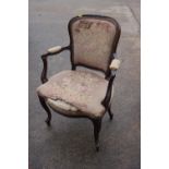 A 19th century French carved walnut showframe open armchair with stuffed over seat and back, on