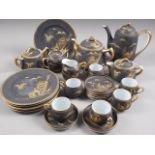 A Japanese eggshell porcelain tea and coffee service for six with gilt landscape decoration on a