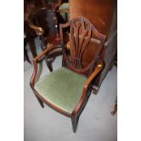 An early 19th century carved mahogany elbow chair of Sheraton design with Gothic pierced splat