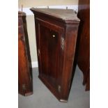 An early 19th century oak and mahogany banded corner hanging cupboard enclosed panelled door, 29"