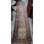 A Herati runner of traditional design on a camel ground, 177" x 40" approx (very worn)